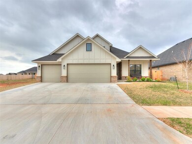 View of front of house featuring a front yard and a garage