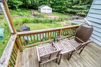 Deck overlooking back yard and 2 car detached garage