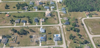 Aerial view of property's location featuring nearby suburban area