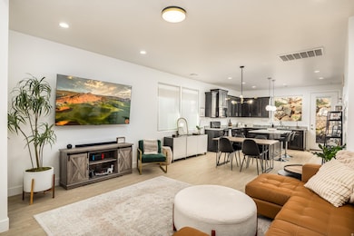 Living room featuring light wood-style flooring and recessed lighting