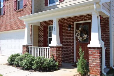 Covered front porch decorated with lovely brick co