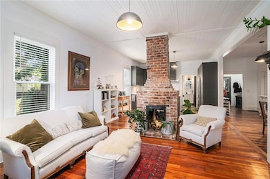 Living area featuring healthy amount of natural light and hardwood / wood-style flooring
