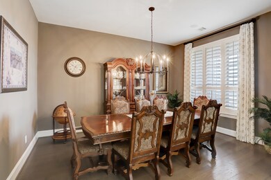 Grand formal dining room in front of home with large picture window and natural light. Dry bar right around the corner!