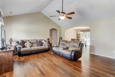 Living room with open floor plan and vaulted ceili
