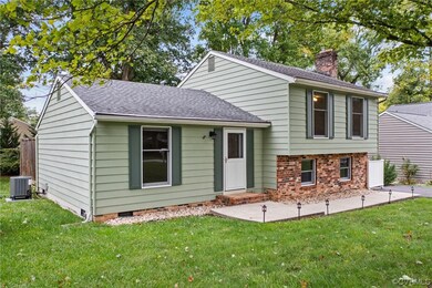 Tri-level home with a front yard and central air c