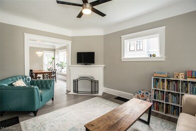 Engineered hardwood floored living room featuring corner fireplace