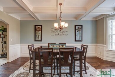 Formal dining room with coffered ceiling and bay w