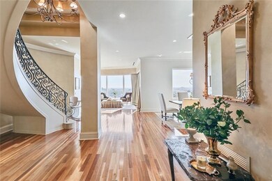 Light filled entry foyer featuring sweeping stairc
