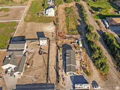 Aerial view of property and surrounding area with a mountain backdrop and nearby suburban area