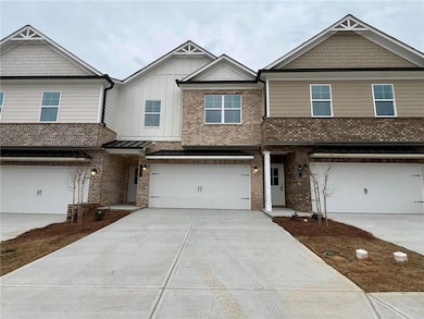 View of front of home with brick siding, an attach