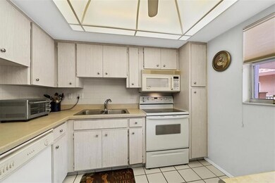 Light color palate in the kitchen with solid surface counters.