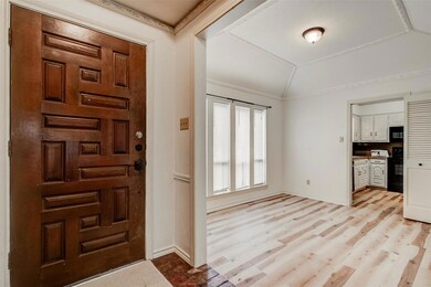front door with formal dining room leading to the 
