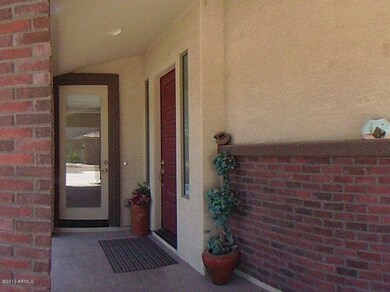 Covered front porch with entry to both m