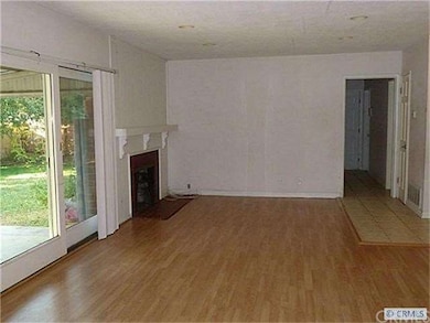Living room with wood floors and fireplace