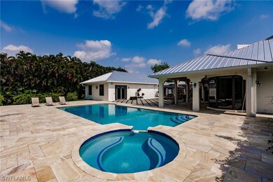 View of pool with a patio and an in ground hot tub