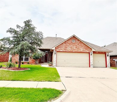 Single story home with a garage and a front yard