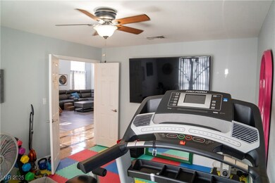 Recreation room featuring ceiling fan and tile pat