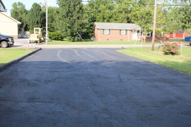 The property features a large paved driveway