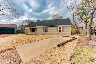 Single story home with brick siding, roof with shi