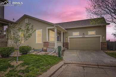 View of front facade with concrete driveway, brick siding, and 2 car garage