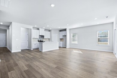 Unfurnished living room with hardwood / wood-style