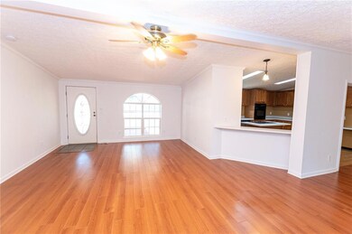 Unfurnished living room with a ceiling fan, a text