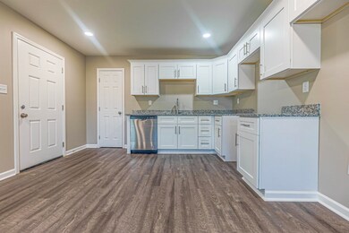 Kitchen with dishwasher, sink, stone countertops, 