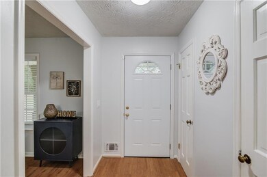 Foyer featuring visible vents, a textured ceiling,