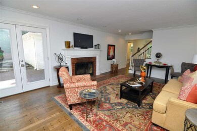 A wood burning fireplace and refinished wood floor