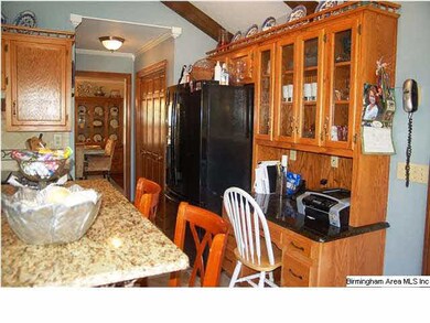 Kitchen desk has glass cabinets above
