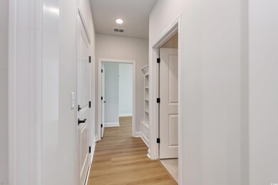 Corridor with light wood-type flooring