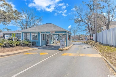 View of street with curbs and a gated entry