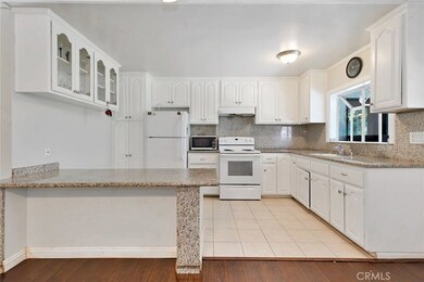 Open Kitchen with Granite Counter Tops and Breakfast Bar
