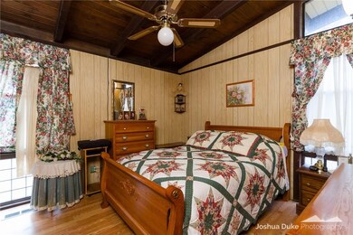 Main floor bedroom has floor to ceiling windows to