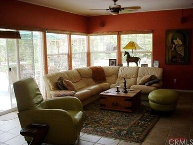 Spacious family room with fireplace opens onto the
