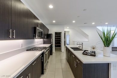 Kitchen featuring stainless steel appliances, a si