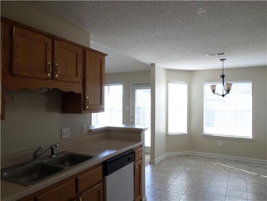 Kitchen also features a large dining area.