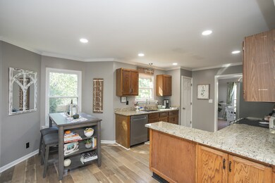 Large Eat-In Kitchen. Granite Counters. SS Appliances. View from entry to Living Room Area. Leads to Dining Room Area and Large Deck on Rear.