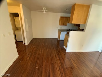 Kitchen with white dishwasher, brown cabinetry, st