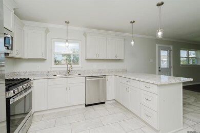 The kitchen has been fully remodeled with all new cabinets, counters, floors and appliances includes refrigerator.