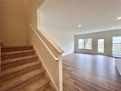 Stairway with wood finished floors, recessed light