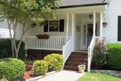 CLOSE UP OF COVERED FRONT PORCH WITH VINL PORCH RA