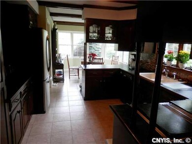 Kitchen Cherry cabinetry & ceramic tile floor in t