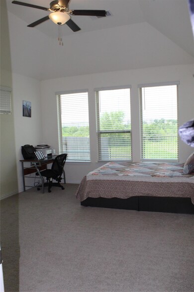Carpeted bedroom featuring lofted ceiling, ceilin