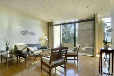 Living room with walls of glass and private patio