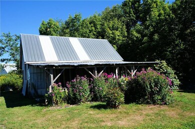 Garage with wood storage on side.
