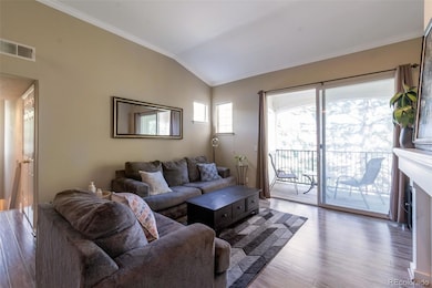Large glass doors fill the space with natural light and open to a private balcony.