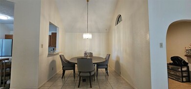 Dining area has tiled flooring and a vaulted ceili