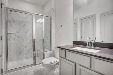 Full bathroom featuring marble finish flooring, t