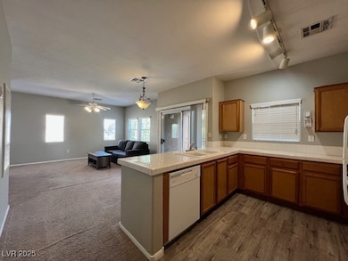 Kitchen featuring white dishwasher, a sink, a peni